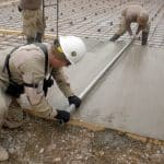 2 Men Levelling a Floor Screed outdoors