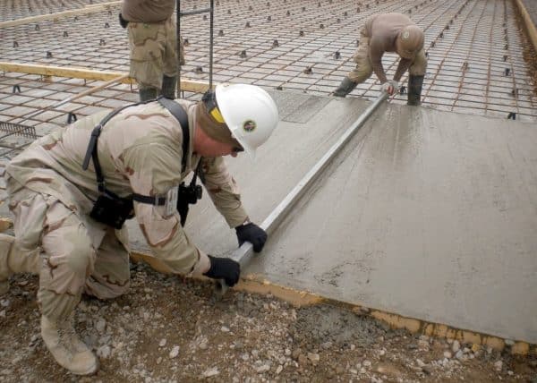 2 Men Levelling a Floor Screed outdoors