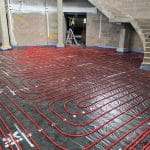 Underfloor Heating installation - red pipes in correct positioning awaiting liquid floor