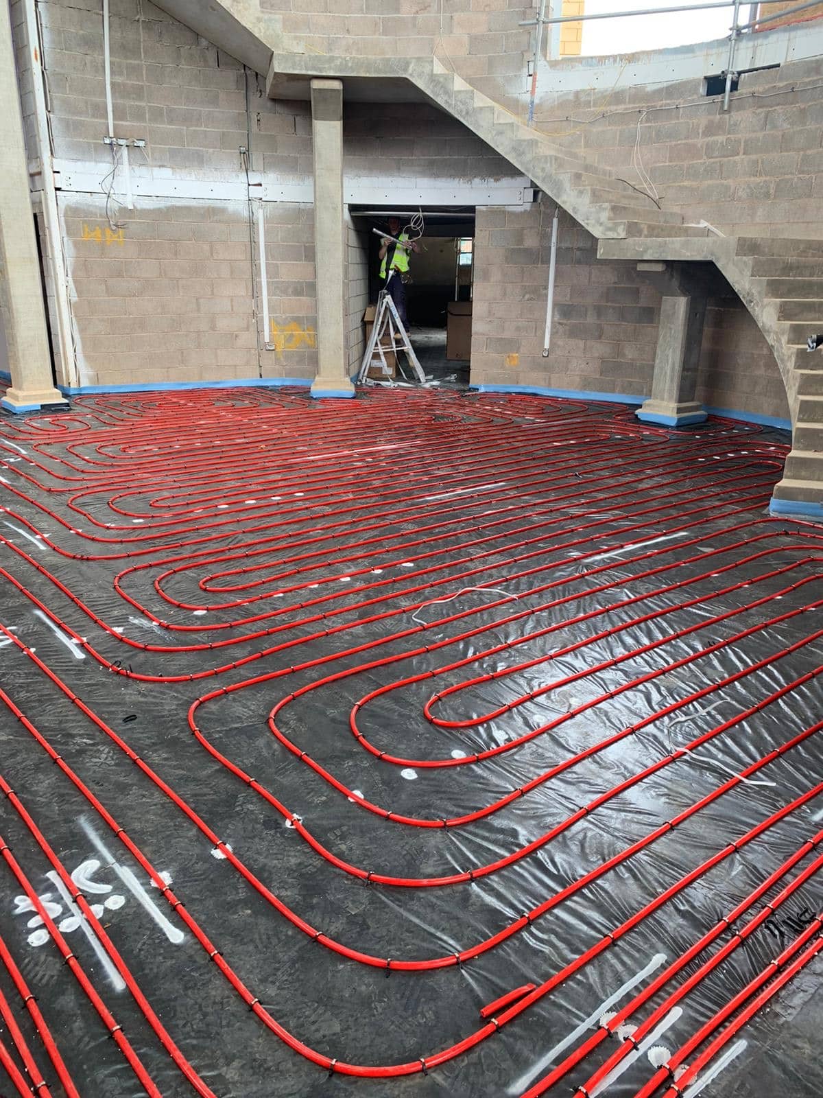 Underfloor Heating installation - red pipes in correct positioning awaiting liquid floor