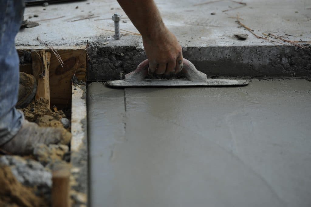 Floor screeding contractors close up of hand and small screeding tool