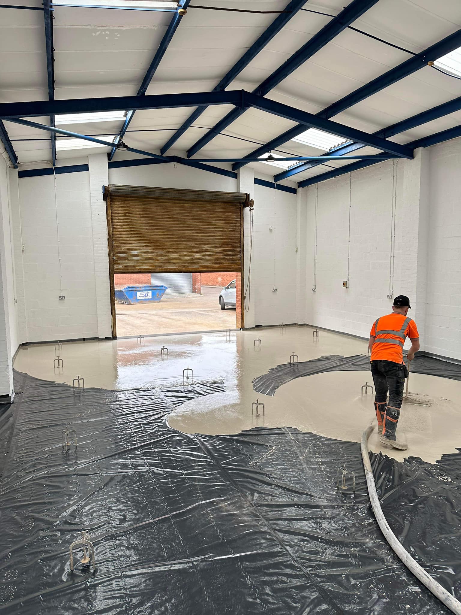 A garage being screeded by liquid floor screed Rugby company: GM Floor Screeds